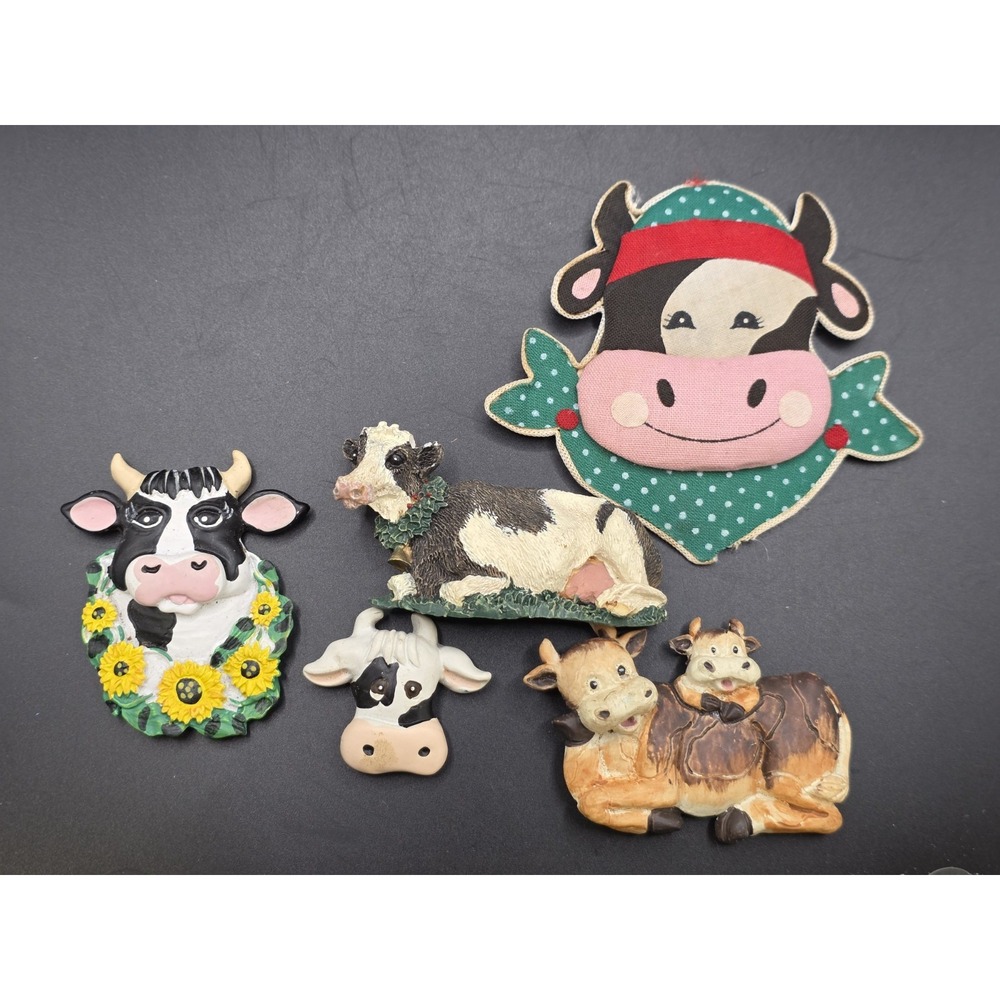 This collection features various vintage-style cow refrigerator magnets